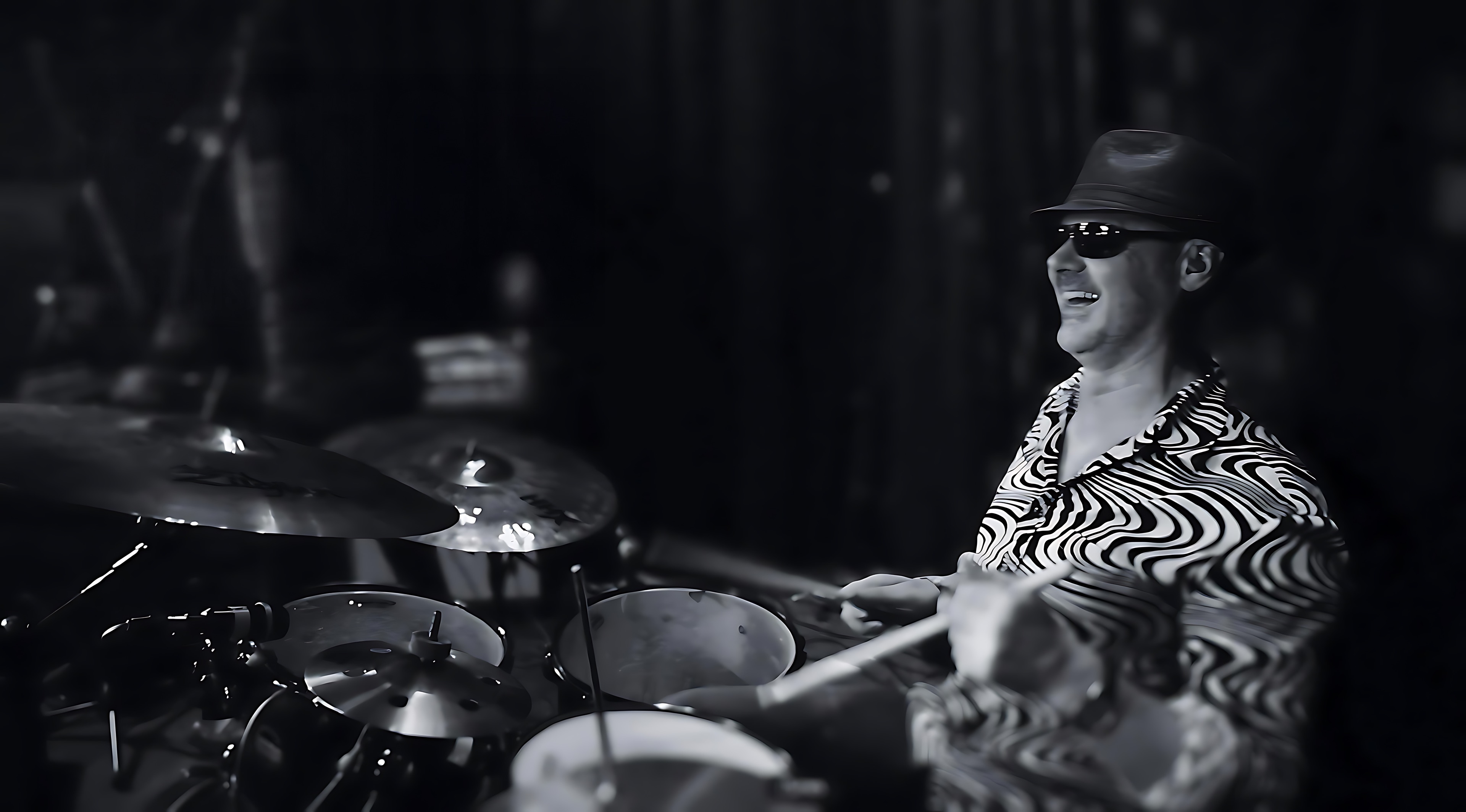 Bruce Mackay behind the kit on a dark stage