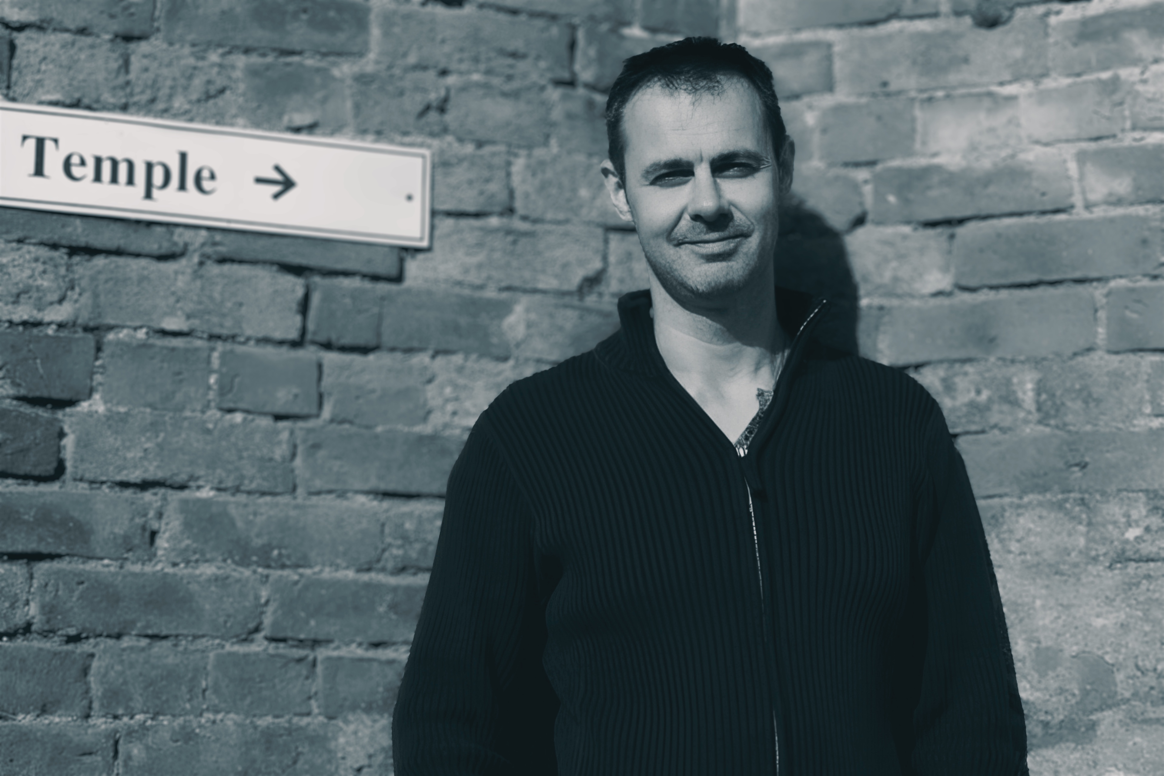 Bruce Mackay beneath a temple sign