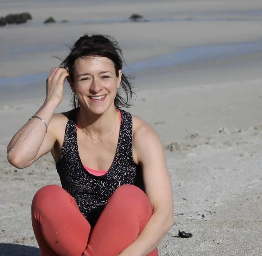 Caroline Foster, a verified YogaPros member, on the beach at Dunbar